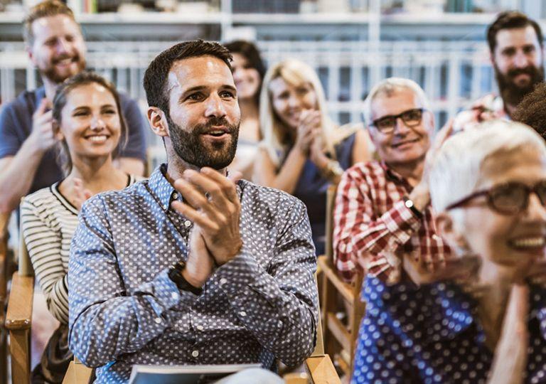 Audience members clapping at an Association of Metals Processors and Distributors event.