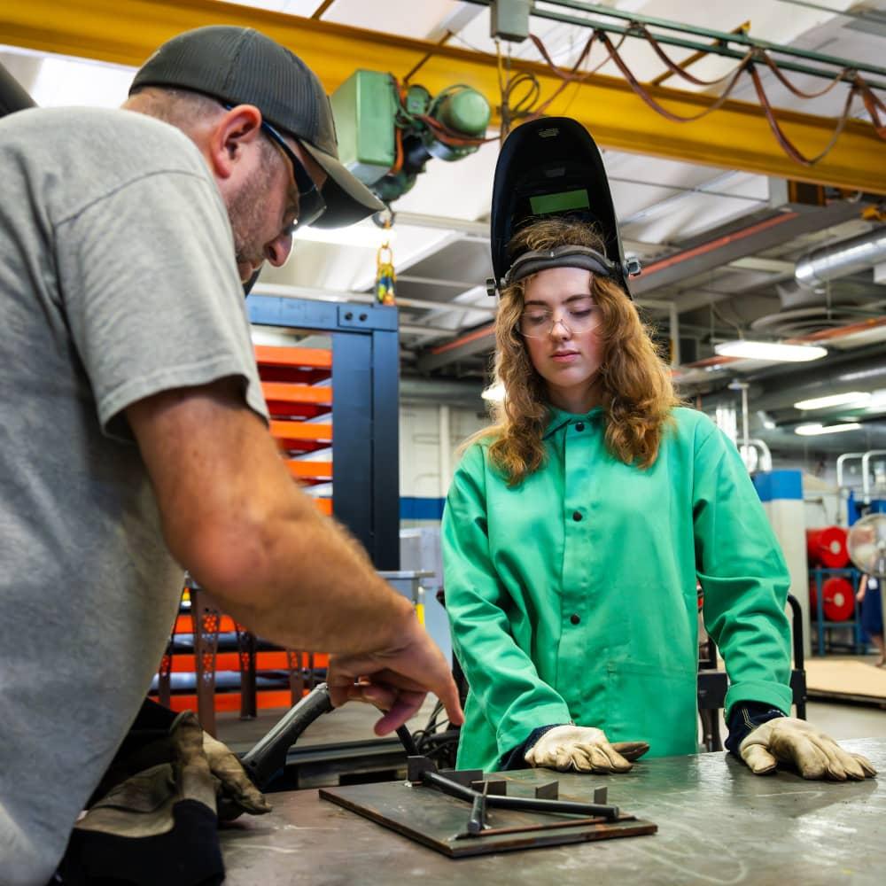 Welding student with instructor