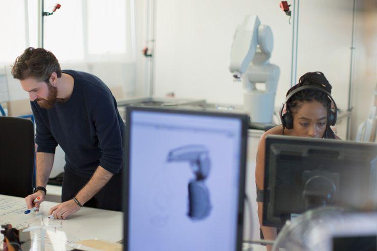 Students in the manufacturing lab at a table with computers on it.